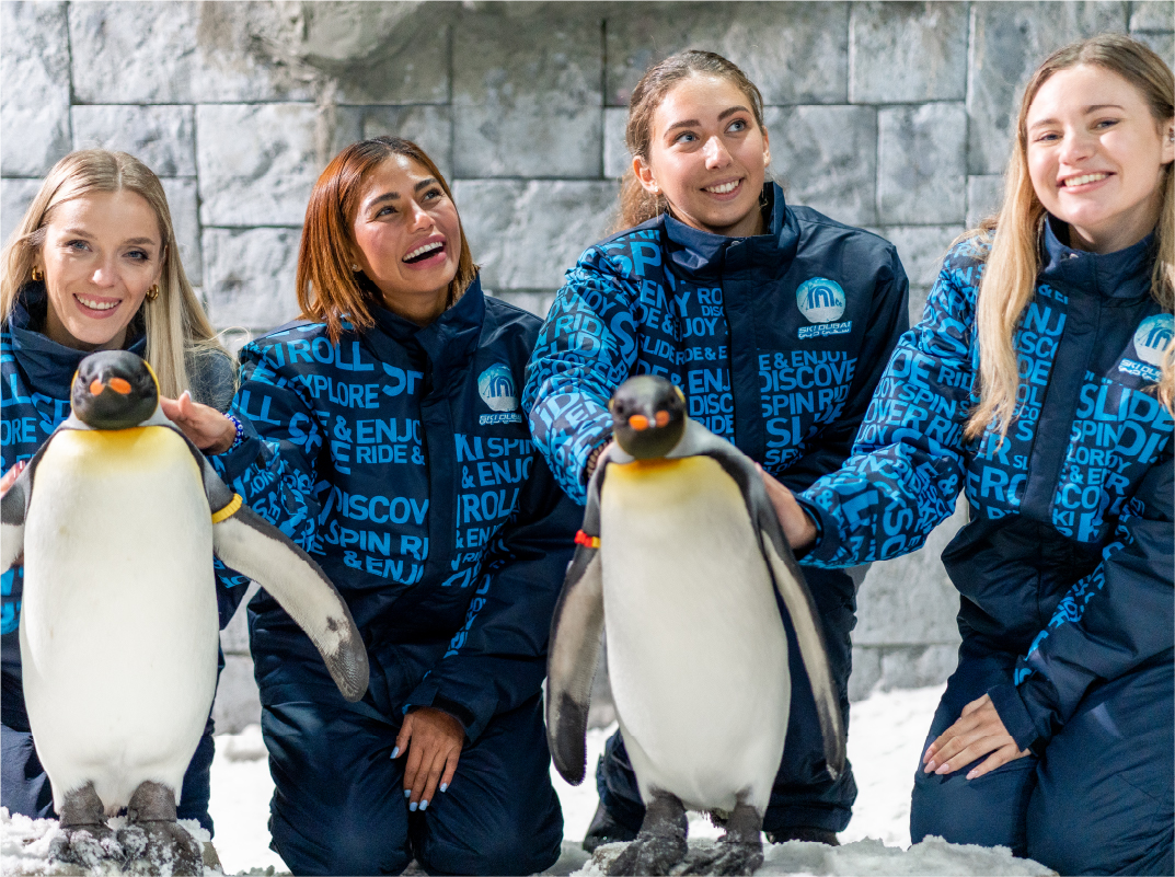 ladies playing with penguins at ski dubai ladies-playing-with-penguins-at-ski-dubai